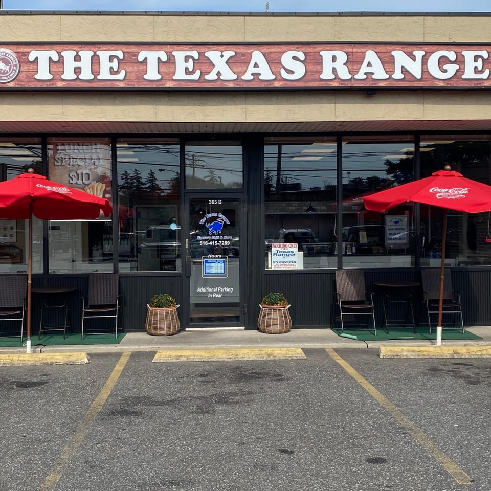The Texas Ranger restaurant exterior with red umbrellas, outdoor seating, and a "Lunch Special $10" sign.