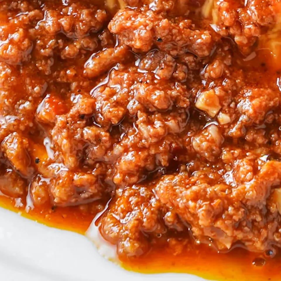 Close-up of a rich, chunky chili con carne, a signature dish at The Texas Ranger.