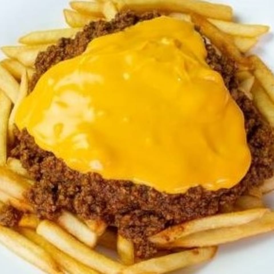 Golden french fries topped with chili and melted yellow cheese, a classic Texas Ranger side.