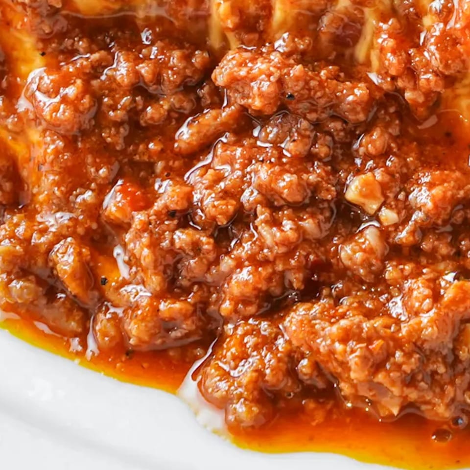 Close-up of a rich, red chili con carne with ground beef, perfect for a Texas Ranger burger.